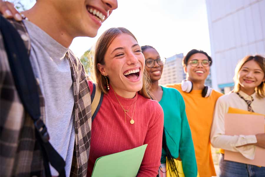 Smiling young adults outdoors with healthy smiles after dental care.